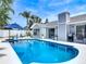 Beautiful backyard pool with a white privacy fence, patio area and lush landscaping at 7 Heather Ln, Ormond Beach, FL 32174