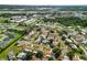 Beautiful aerial view of a neighborhood with lush trees and a view of the river at 708 Egret Ct, Edgewater, FL 32141