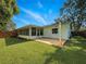 The lush backyard has a patio, grass, and lots of plants at 708 Egret Ct, Edgewater, FL 32141
