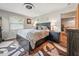 Comfortable bedroom featuring a ceiling fan, an area rug, and an ensuite entrance at 708 Egret Ct, Edgewater, FL 32141