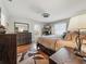 Relaxing bedroom with hardwood floors, two windows and warm, natural light at 708 Egret Ct, Edgewater, FL 32141
