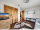 Cozy bedroom with wood-look floors, spacious closet, a tv, and sunny natural light at 708 Egret Ct, Edgewater, FL 32141