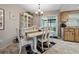 Comfortable dining area featuring an elegant white table set, cabinet, and sliding door access at 708 Egret Ct, Edgewater, FL 32141