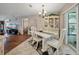 Bright dining room with white table set, china cabinet, and sliding door access to the outside at 708 Egret Ct, Edgewater, FL 32141