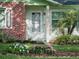 Close-up of front entrance with attractive landscaping, flower beds, and a charming, well-maintained entryway at 708 Egret Ct, Edgewater, FL 32141