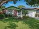 Charming single-story home with well-maintained lawn and colorful flower bed in a sunny, suburban setting at 708 Egret Ct, Edgewater, FL 32141