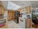 Cozy kitchen features classic appliances, wooden cabinets, and a bright, modern lighting fixture at 708 Egret Ct, Edgewater, FL 32141