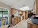 Well-lit kitchen with wooden cabinets, modern appliances, and easy access to the enclosed patio at 708 Egret Ct, Edgewater, FL 32141