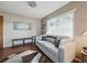 This living room features a comfortable couch next to a bright window with natural light at 708 Egret Ct, Edgewater, FL 32141