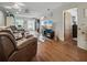 Well-lit living room boasts hardwood floors, neutral paint, and modern ceiling fan at 708 Egret Ct, Edgewater, FL 32141