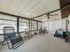 The sunroom is a relaxing place to spend time with a ceiling fan and many windows at 708 Egret Ct, Edgewater, FL 32141