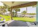 Inviting covered porch area with a view of lush landscaping and waterfront at 76 Heather Point Ct, New Smyrna Beach, FL 32169