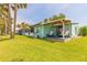 Scenic backyard featuring a covered porch with seating, perfect for outdoor relaxation at 76 Heather Point Ct, New Smyrna Beach, FL 32169