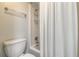Well-lit bathroom featuring a shower and tub with a white shower curtain at 76 Heather Point Ct, New Smyrna Beach, FL 32169