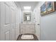 Well-lit bathroom vanity area with a large mirror and lots of closet space at 76 Heather Point Ct, New Smyrna Beach, FL 32169