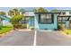 Inviting villa with guest parking and tropical landscaping at waterfront community at 76 Heather Point Ct, New Smyrna Beach, FL 32169