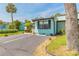 Single-story villa with guest parking, tidy landscaping and mature trees at 76 Heather Point Ct, New Smyrna Beach, FL 32169