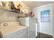 A close up of the well-maintained laundry area featuring shelving with storage at 76 Heather Point Ct, New Smyrna Beach, FL 32169