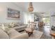 Inviting living room featuring stylish coastal decor and a unique seashell chandelier at 76 Heather Point Ct, New Smyrna Beach, FL 32169