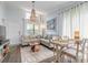 Open-concept living room with dining area, comfortable seating, and beach-themed decor at 76 Heather Point Ct, New Smyrna Beach, FL 32169