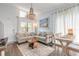 Bright living room with a comfortable sectional sofa, coastal decor and a beach-themed artwork at 76 Heather Point Ct, New Smyrna Beach, FL 32169