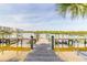 Scenic view of calm waterway with dock, adjacent to community condominium buildings at 76 Heather Point Ct, New Smyrna Beach, FL 32169
