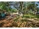 Expansive backyard features mature trees, a brick patio, and ample space for outdoor entertaining at 804 E 12Th Ave, New Smyrna Beach, FL 32169