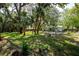 Backyard with a swimming pool surrounded by tropical plants at 804 E 12Th Ave, New Smyrna Beach, FL 32169