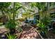 Backyard patio area surrounded by lush tropical landscaping at 804 E 12Th Ave, New Smyrna Beach, FL 32169