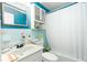 Bathroom with blue tile, vanity, and shower at 804 E 12Th Ave, New Smyrna Beach, FL 32169