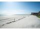 Wide-angle beach view with ocean, sandy beach, and condos in the distance at 804 E 12Th Ave, New Smyrna Beach, FL 32169