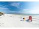 Wide, sandy beach featuring a lifeguard chair and convenient trash receptacles with blue skies at 804 E 12Th Ave, New Smyrna Beach, FL 32169