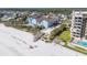 Aerial view of beachfront condos with a pool, beach access, and lifeguard station on white sands at 804 E 12Th Ave, New Smyrna Beach, FL 32169