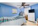 Comfortable bedroom with blue walls, ceiling fan, and dresser at 804 E 12Th Ave, New Smyrna Beach, FL 32169