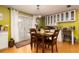 Dining area featuring a wooden table with seating for four, hardwood floors, and a view of the backyard at 804 E 12Th Ave, New Smyrna Beach, FL 32169