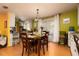 Dining room with hardwood floors, a chandelier, and a wooden table with four chairs at 804 E 12Th Ave, New Smyrna Beach, FL 32169