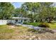Charming single story home with front yard, lush trees, and inviting seating area at 804 E 12Th Ave, New Smyrna Beach, FL 32169