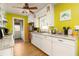 Bright kitchen with white cabinets, granite countertops, modern appliances, and hardwood floors at 804 E 12Th Ave, New Smyrna Beach, FL 32169