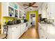 Bright kitchen with white cabinets, granite countertops, appliances, and hardwood floors at 804 E 12Th Ave, New Smyrna Beach, FL 32169