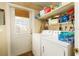 Utility area with a washer, dryer, shelving, and backyard access at 804 E 12Th Ave, New Smyrna Beach, FL 32169