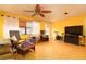 Bright living room with ceiling fan, hardwood floors, sofa, and rocking chair at 804 E 12Th Ave, New Smyrna Beach, FL 32169