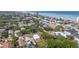 An aerial view displays neighborhood homes and trees along a Florida coastline with white sand at 833 E 12Th Ave, New Smyrna Beach, FL 32169