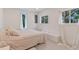Bright bedroom features natural light, a comfortable bed, and a serene, minimalist design at 833 E 12Th Ave, New Smyrna Beach, FL 32169