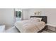 Comfortable bedroom featuring a plush bed, neutral tones, and a large window that floods the room with natural light at 833 E 12Th Ave, New Smyrna Beach, FL 32169