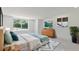 Calm bedroom with a comfortable bed, dresser, stylish rug, and a window overlooking the lush yard at 833 E 12Th Ave, New Smyrna Beach, FL 32169