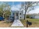 Striking two-story home featuring a unique facade, well-manicured lawn, and inviting front entryway with a modern mailbox at 833 E 12Th Ave, New Smyrna Beach, FL 32169