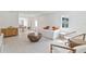 Bright, open living area featuring modern decor, white floors, and a neutral color scheme complemented by a dining area at 833 E 12Th Ave, New Smyrna Beach, FL 32169