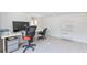 Home office with two desks and chairs, neutral paint, light flooring, and a large window for natural light at 833 E 12Th Ave, New Smyrna Beach, FL 32169