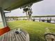Serene backyard view with a table, chairs and waterfront access at 84 Heather Point Ct, New Smyrna Beach, FL 32169