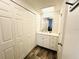Bathroom featuring wood floors, white vanity, modern countertop and medicine cabinet at 84 Heather Point Ct, New Smyrna Beach, FL 32169